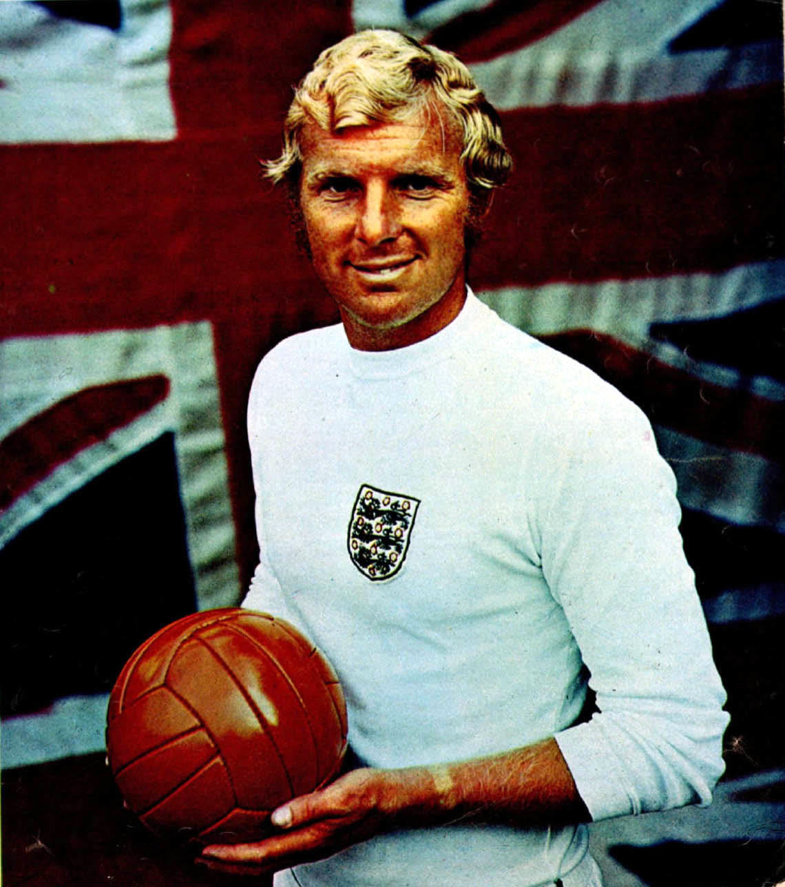 Bobby Moore in an England shirt holding a football in 1970