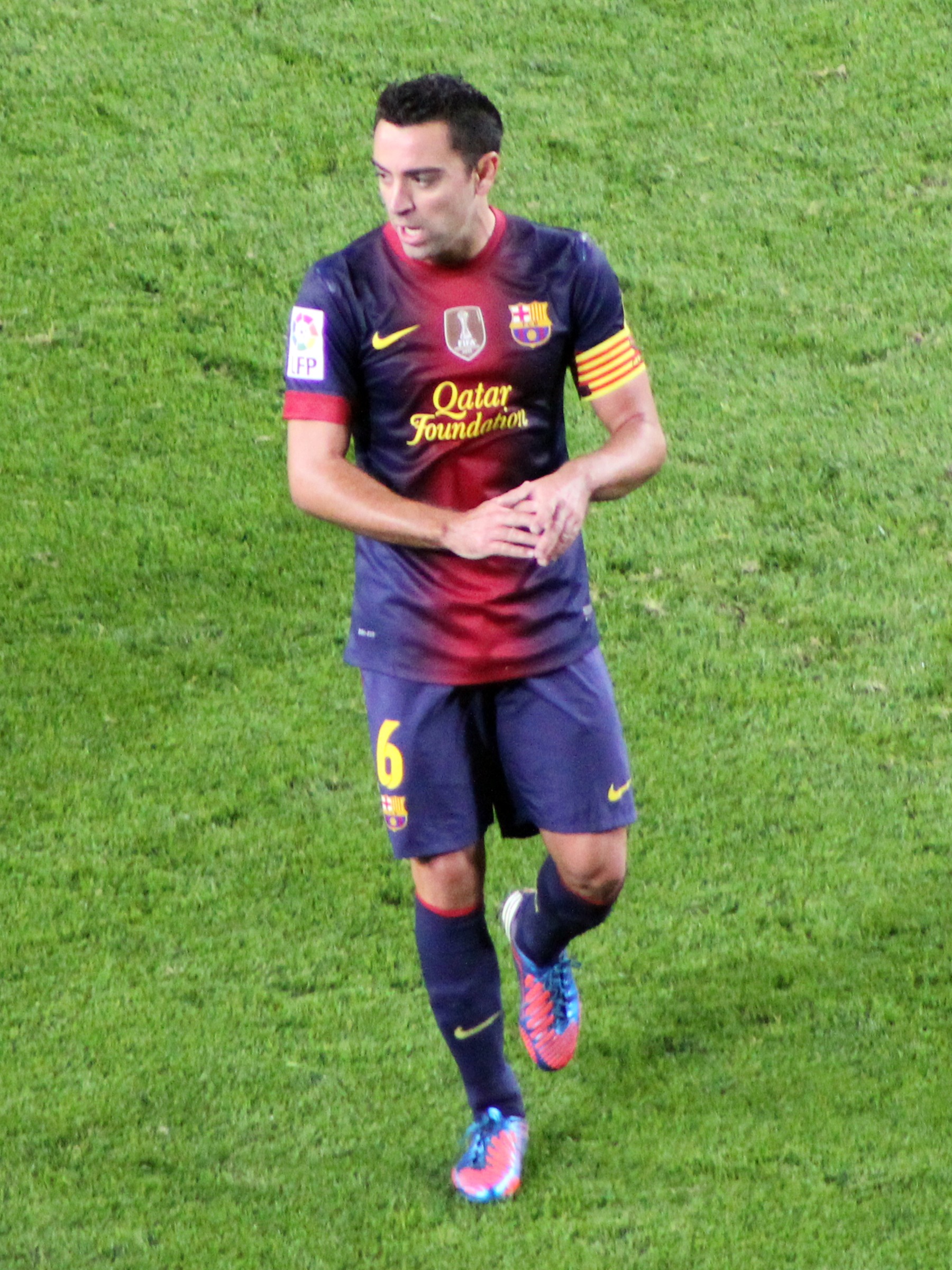 Xavi wearing Barcelona's number 6 kit and captain's armband on the pitch in 2012.